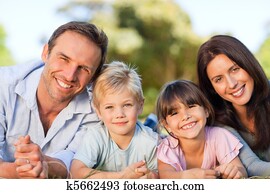 Family lying down in the park Family lying down in the park