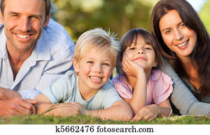 Family lying down in the park
