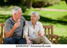 Senior couple eating an ice cream o Senior couple eating an ice cream o