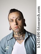 Man with tattoos and piercings.