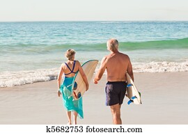 Couple with their surfboard on the