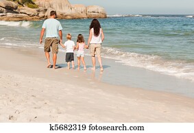 Family walking on the beach Family walking on the beach