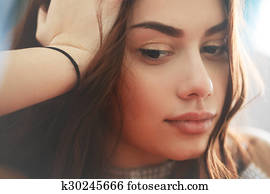 Pensive sad and thoughtful young woman