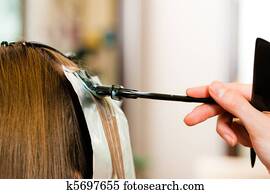 At the hairdresser ? woman gets new hair colour