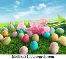 Easter eggs with pink tulips on grass Easter eggs with pink tulips on grass