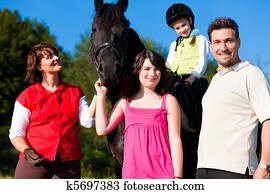 Family and children posing with horse Family and children posing with horse