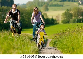 Family riding bicycles in summer Family riding bicycles in summer