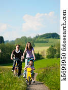 Family riding bicycles in summer Family riding bicycles in summer