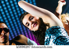 Friends dancing in club or disco