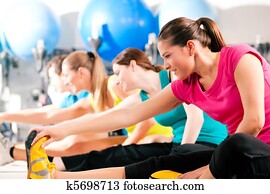 People in gym warming up stretching People in gym warming up stretching