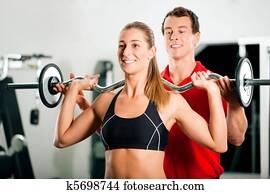 Woman with Personal Trainer in gym Woman with Personal Trainer in gym