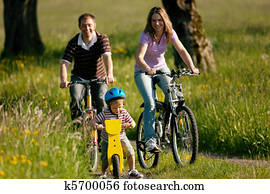 Family riding bicycles in summer Family riding bicycles in summer
