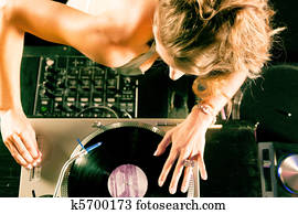 Female DJ at the turntable in Club