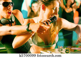 Two DJs at the turntable in club