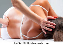 Osteopath doing cranial sacral exercise on woman. Osteopath doing cranial sacral exercise on woman.