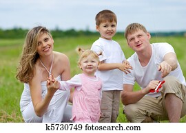 Happy family fly a kite together in summer field Happy family fly a kite together in summer field