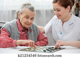 Senior woman playing checkers Senior woman playing checkers