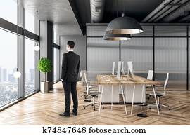 Businessman in minimalist coworking office interior