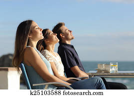 Group of friends breathing fresh air in a restaurant on the beach