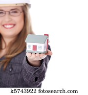 Young beautiful business woman with house model
