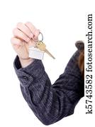 Young businesswoman with house keys in hand 