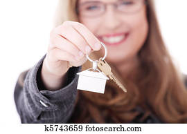 Young businesswoman with house keys in hand 