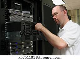 Computer Technician/network administrator working on a server. Computer Technician/network administrator working on a server.