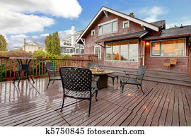 Large brown house with back deck exterior rain winter shot
