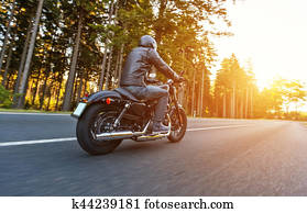 Back view of motorcycle driver on road Back view of motorcycle driver on road
