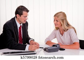 Woman signs a contract in an office Woman signs a contract in an office