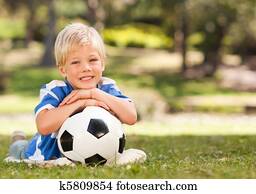 Boy with his ball in the park Boy with his ball in the park