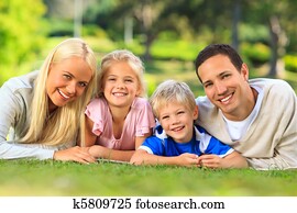 Family lying down in the park Family lying down in the park