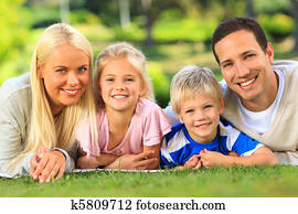Family lying down in the park Family lying down in the park