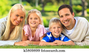 Family lying down in the park Family lying down in the park