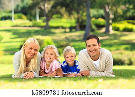 Family lying down in the park Family lying down in the park