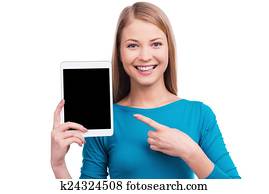 göra, dig, vilja, sådan, tablet?, vacker, unga kvinnor, holdingen, digital tablet, och, pekande, på, den, medan, stående, mot, vit fond