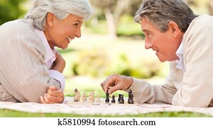 Elderly couple playing chess Elderly couple playing chess