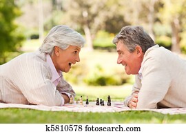 Retired couple playing chess Retired couple playing chess