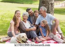 Extended family with their pet dog at park