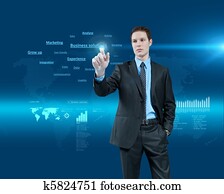 Young businessman choosing business solutions in holographic virtual reality interface. Future collection. One of a series. Young businessman choosing business solutions in holographic virtual reality interface. Future collection. One of a series.