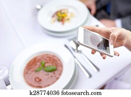 close up of couple with smartphones at restaurant close up of couple with smartphones at restaurant