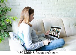 Woman having video call with colleagues Woman having video call with colleagues