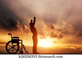 A disabled man standing up from wheelchair. Cure, medical miracle. A disabled man standing up from wheelchair. Cure, medical miracle.
