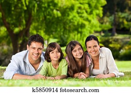 Family lying down in the park Family lying down in the park