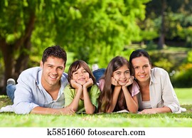 Family lying down in the park