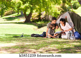 Joyful family camping in the park Joyful family camping in the park