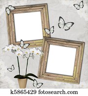Wooden frames with butterfly and orchids on grange background Wooden frames with butterfly and orchids on grange background