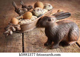 Brown easter eggs with antique bunny on wood