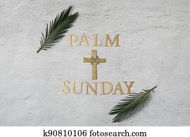 Palm sunday background. Cross and palm on grey background.