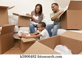 African American Family Unpacking Boxes Moving House